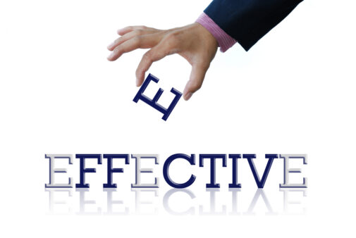 a hand placing the letter E into the word effective