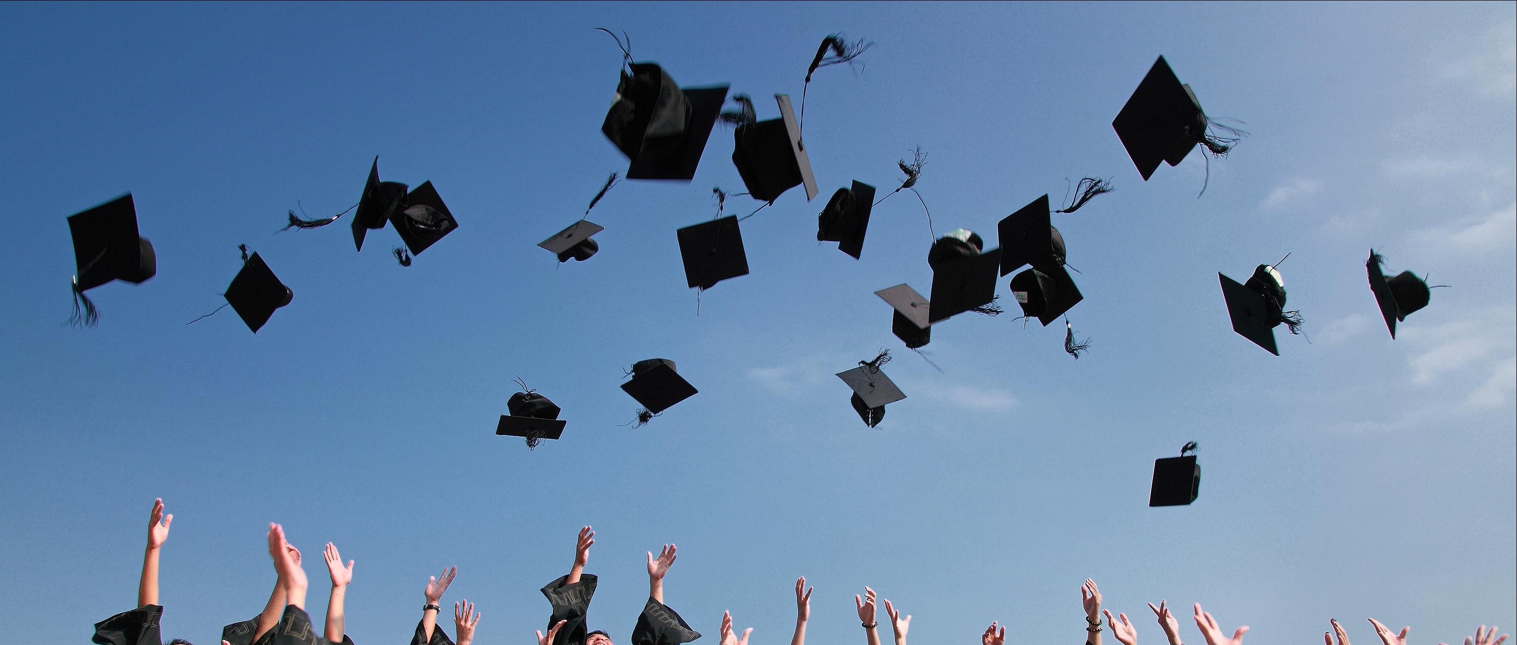 Mortarboards tossed in the air