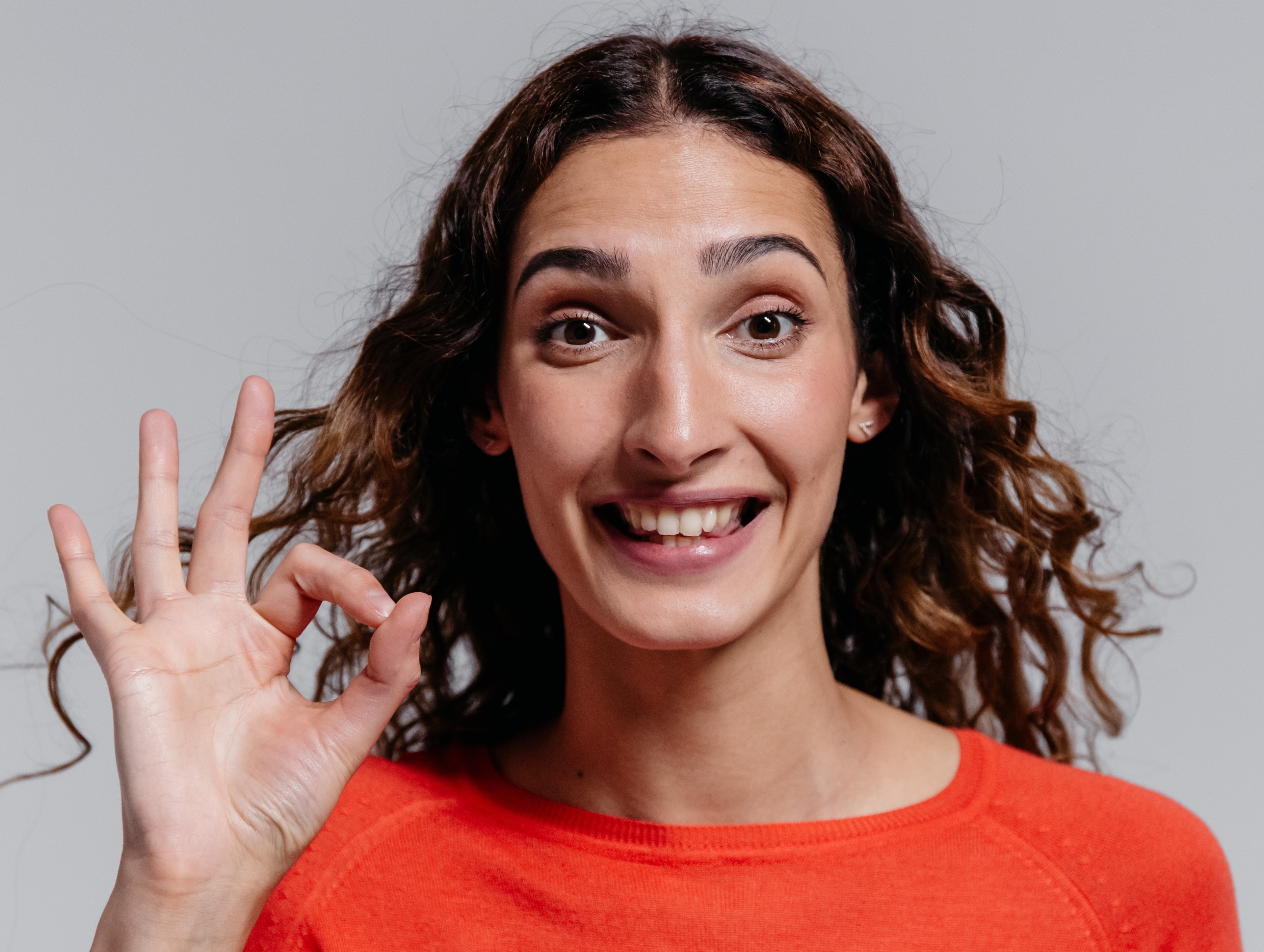 woman showing OK sign with her fingers