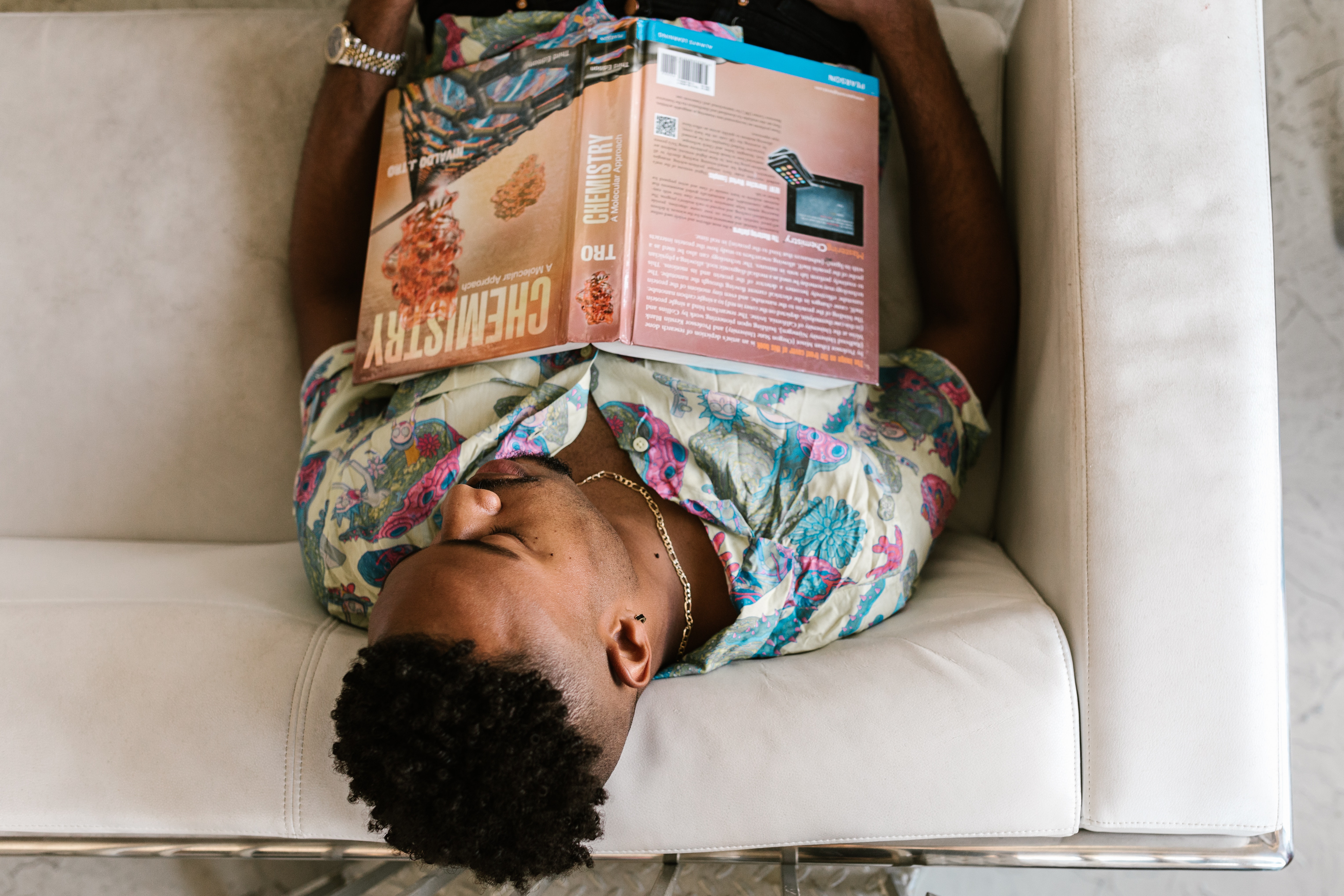 photo of student sleeping with chemistry text on their chest